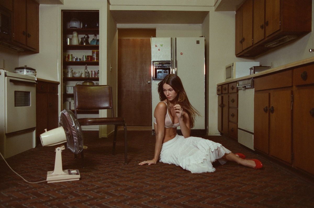 retro kitchen,  young girl in front of an electric fan 