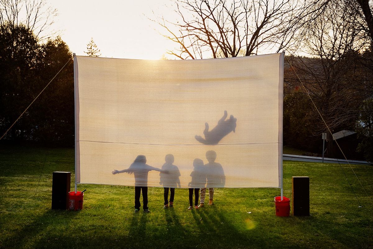 kids shadow behind sheet 