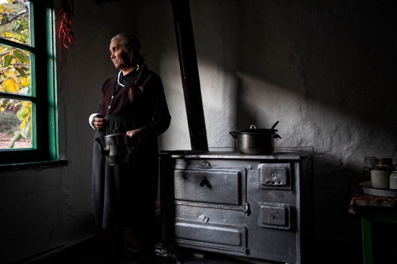 woman standing in a kitchen facing window