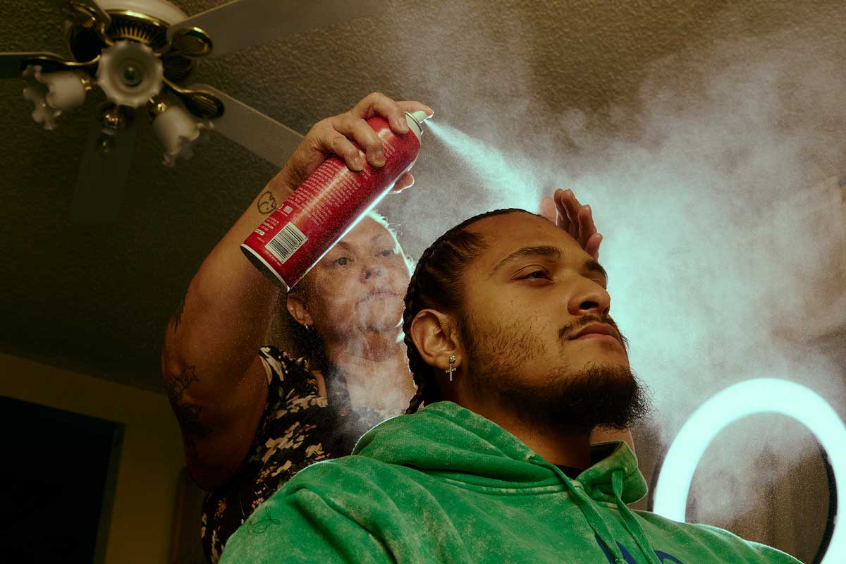 Winning selection of an image of a young man visiting a hair salon with hair spray being applied